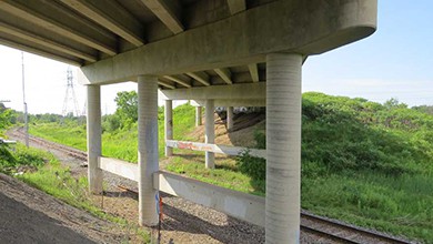 Concrete bridge from below with train tracks